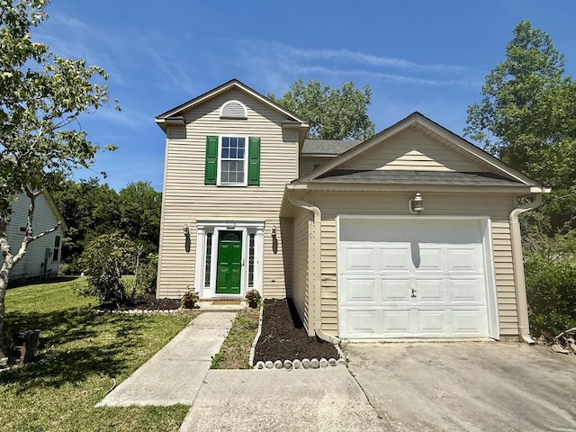 traditional-style home featuring concrete driveway, an attached garage, and a front yard