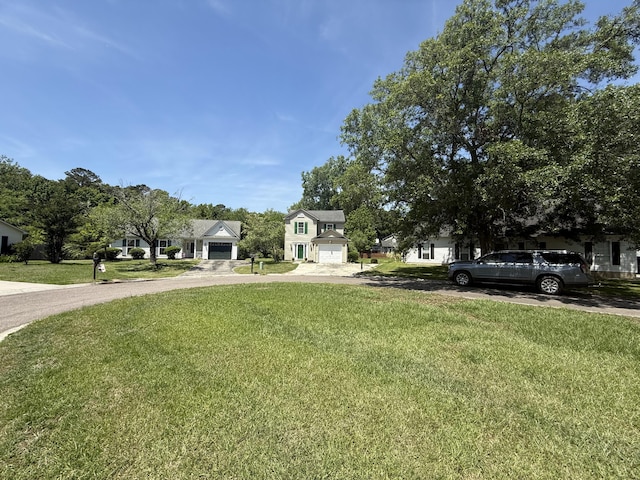 view of front facade featuring a garage, driveway, and a front lawn