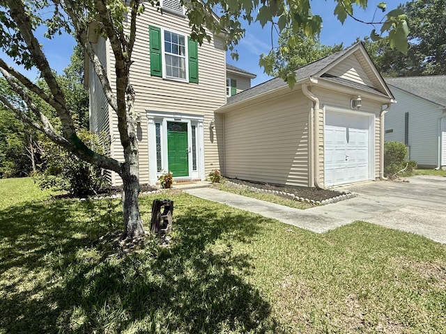 view of front of home with concrete driveway, an attached garage, and a front lawn
