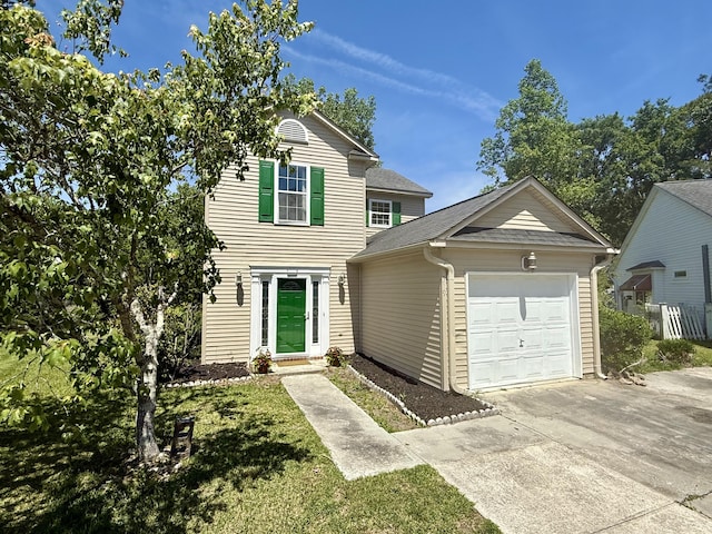 traditional home featuring concrete driveway and an attached garage
