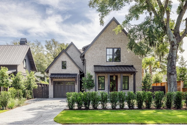 modern farmhouse style home featuring a garage and a front lawn