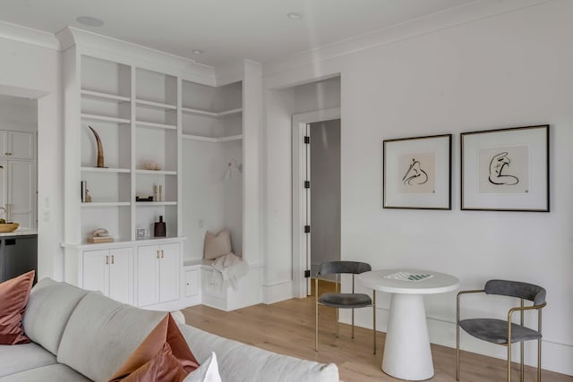 interior space with ornamental molding and light hardwood / wood-style flooring