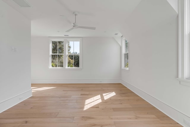 empty room with ceiling fan and light hardwood / wood-style floors