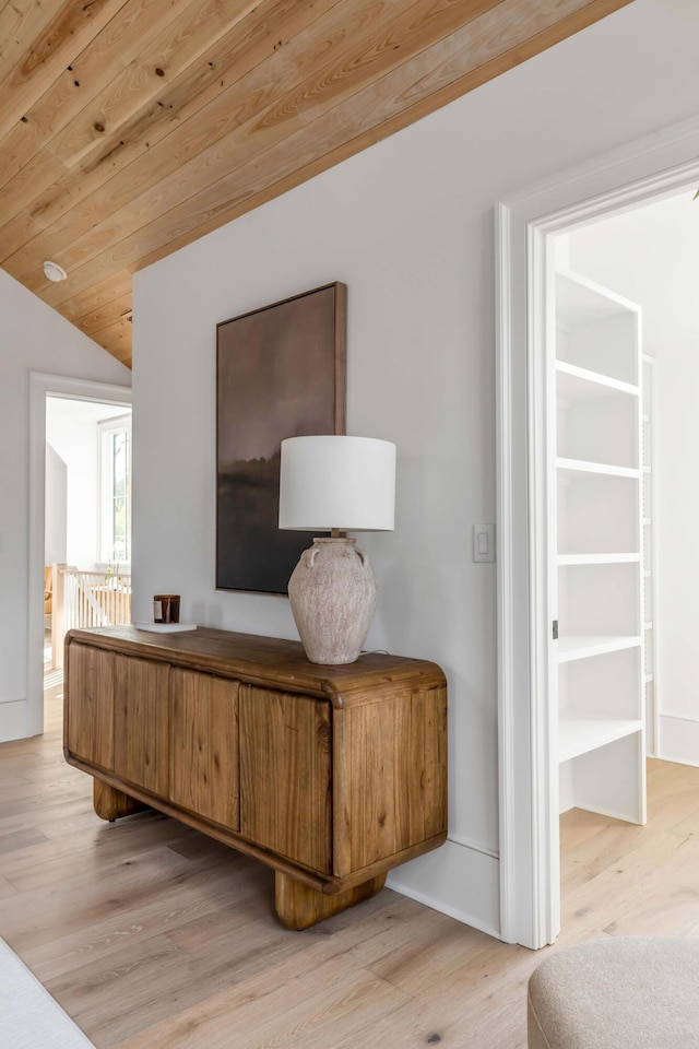 interior space with vaulted ceiling, wooden ceiling, and light wood-type flooring