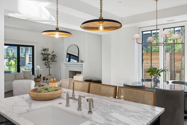 dining room featuring sink and a notable chandelier