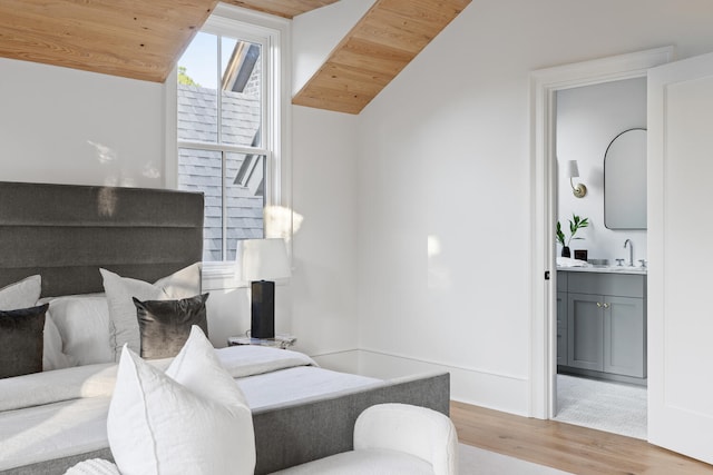 bedroom featuring sink, wood ceiling, vaulted ceiling, and light hardwood / wood-style floors