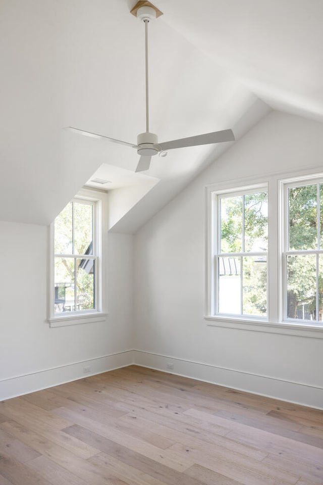 additional living space with vaulted ceiling, plenty of natural light, and light hardwood / wood-style floors