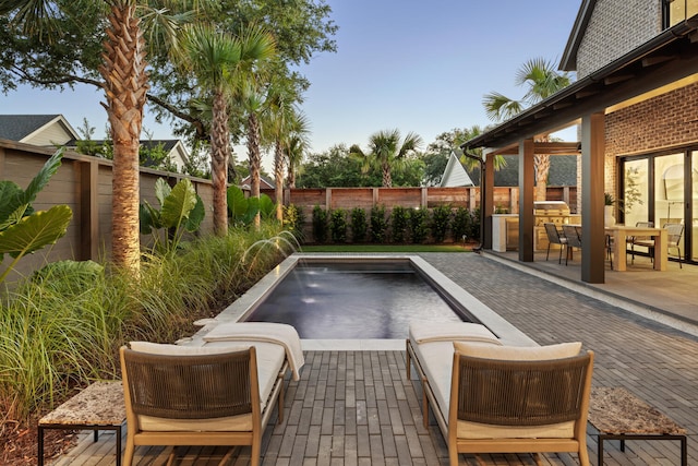 view of swimming pool with pool water feature and a patio area