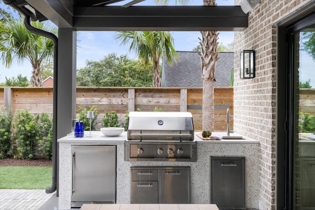 view of patio / terrace featuring an outdoor kitchen and grilling area