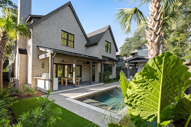 rear view of property with a patio area