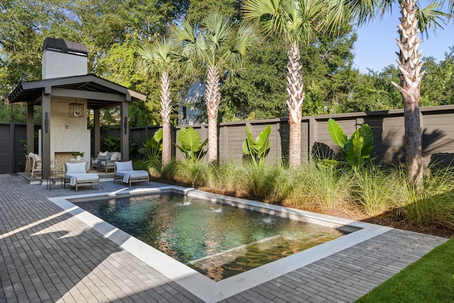 view of swimming pool featuring pool water feature, an outdoor hangout area, and a patio area