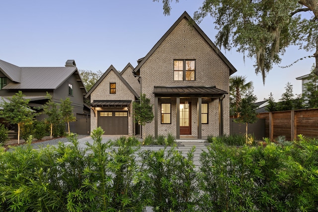 view of front of property featuring a garage and covered porch