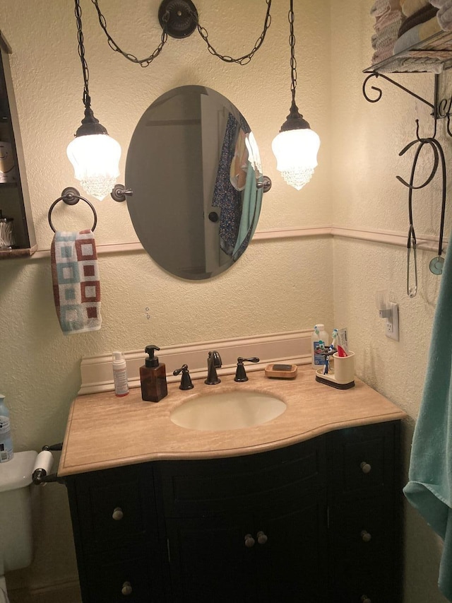 bathroom with toilet and vanity