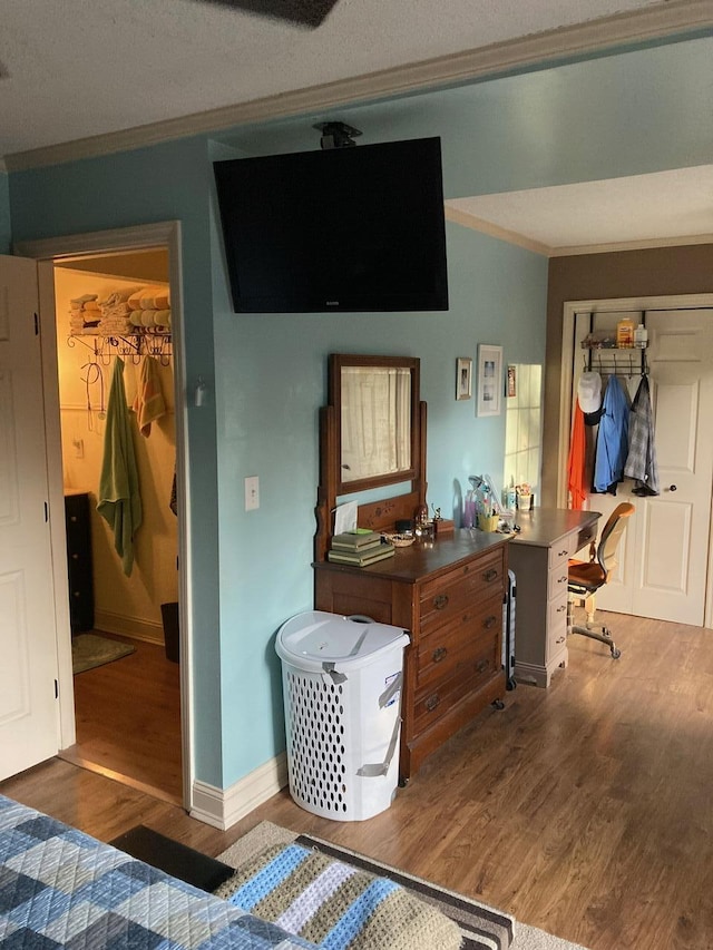 bedroom featuring ornamental molding and dark hardwood / wood-style flooring