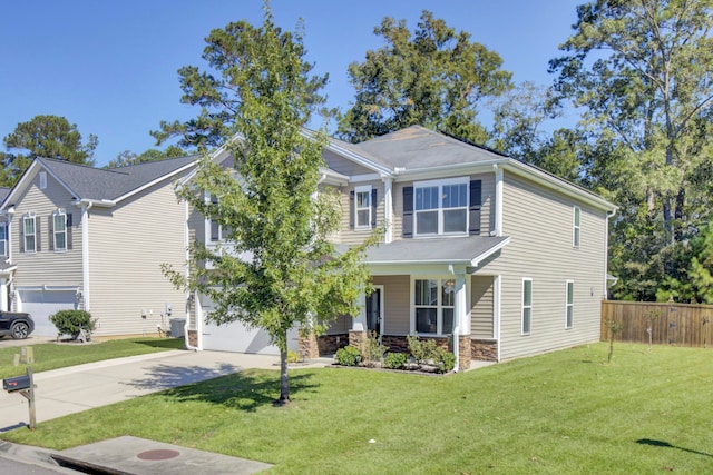 view of front of property featuring a front yard and a garage