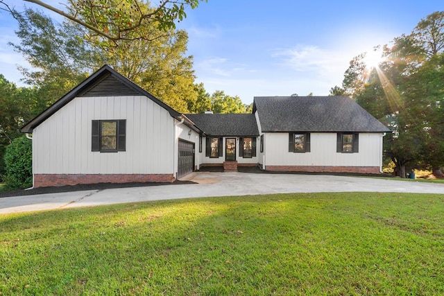 view of front of home with a front yard and a garage