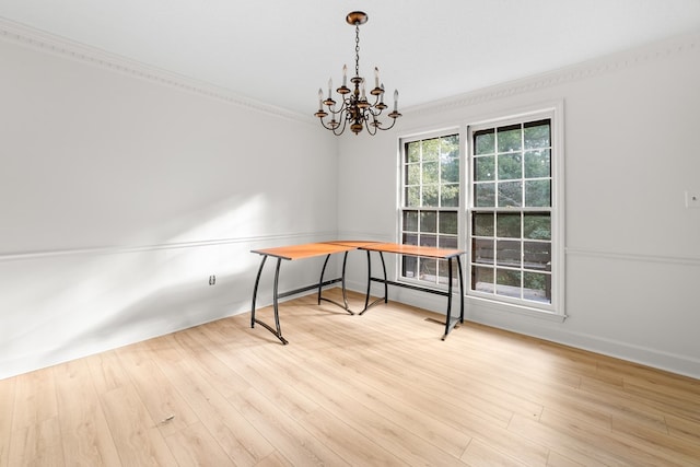 home office featuring ornamental molding, light hardwood / wood-style floors, and an inviting chandelier