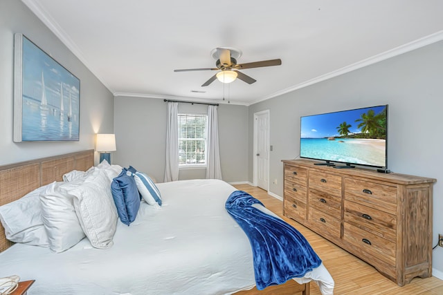 bedroom featuring ceiling fan, ornamental molding, and light wood-type flooring