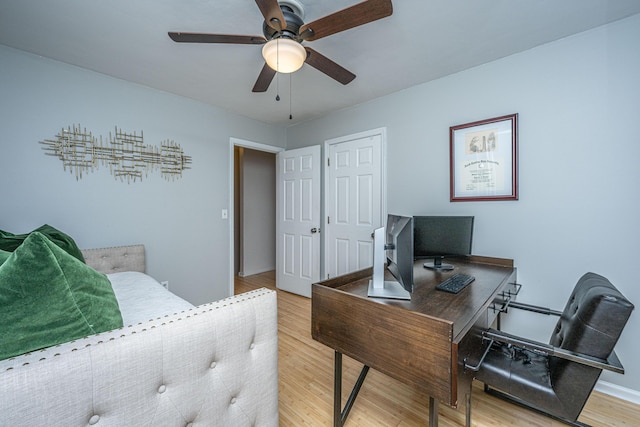 home office featuring ceiling fan and light hardwood / wood-style floors