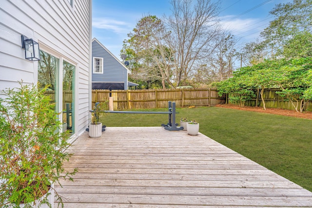 wooden terrace featuring a lawn