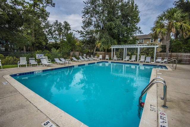 view of swimming pool featuring a pergola and a patio