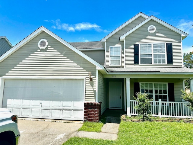 front of property featuring a garage, a front lawn, and a porch