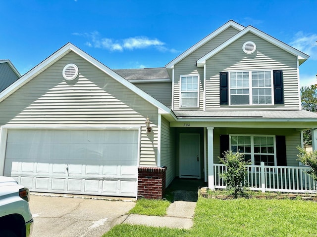 traditional home with a porch, a front yard, driveway, and an attached garage