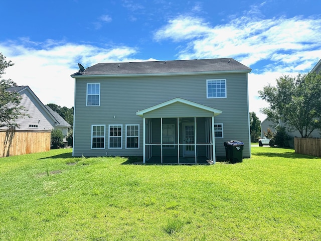 back of house with a yard, fence, and a sunroom