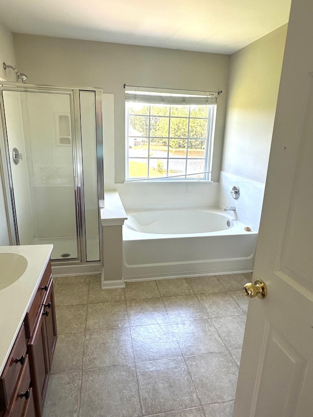 bathroom with a garden tub, vanity, and a shower stall