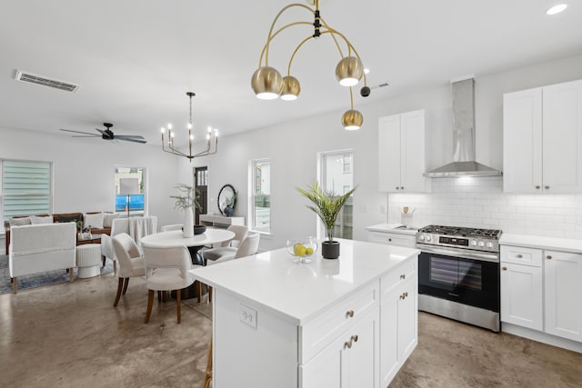 42 Poinsett St Unit B, Charleston, SC 29403 - kitchen with wall chimney range hood, stainless steel gas range oven, finished concrete flooring, a chandelier, and backsplash