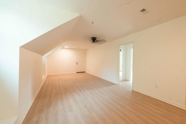 additional living space with ceiling fan, lofted ceiling, and light wood-type flooring