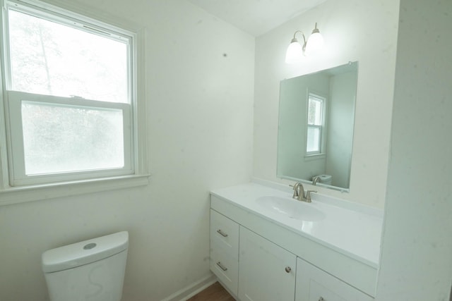 bathroom featuring vanity and toilet