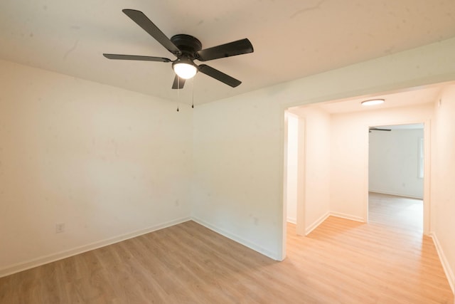 empty room with light wood-type flooring and ceiling fan