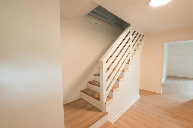 stairway with hardwood / wood-style flooring