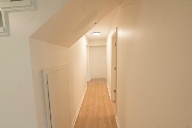 corridor with light hardwood / wood-style flooring