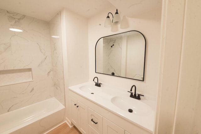 bathroom featuring tiled shower / bath combo, wood-type flooring, and vanity