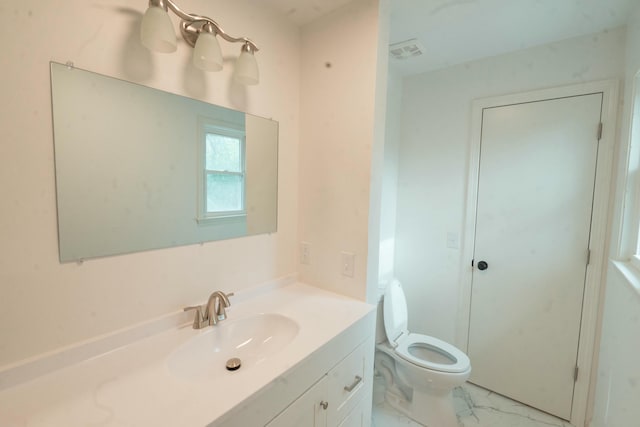 bathroom featuring vanity and toilet