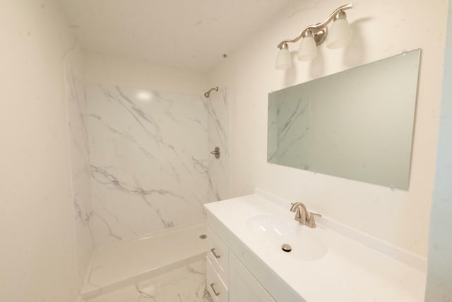 bathroom featuring vanity and a tile shower