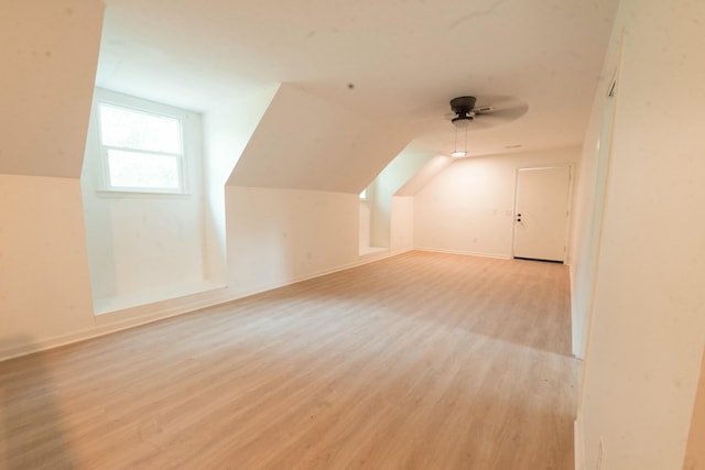 bonus room featuring light hardwood / wood-style floors, vaulted ceiling, and ceiling fan