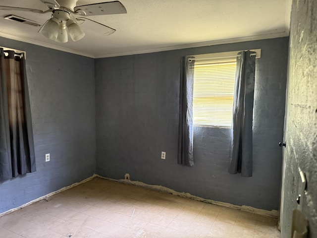 empty room featuring crown molding, visible vents, tile patterned floors, and a ceiling fan