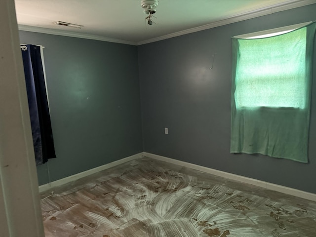 spare room featuring visible vents, crown molding, and baseboards