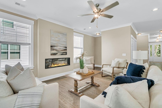 living room with ceiling fan, hardwood / wood-style floors, and crown molding