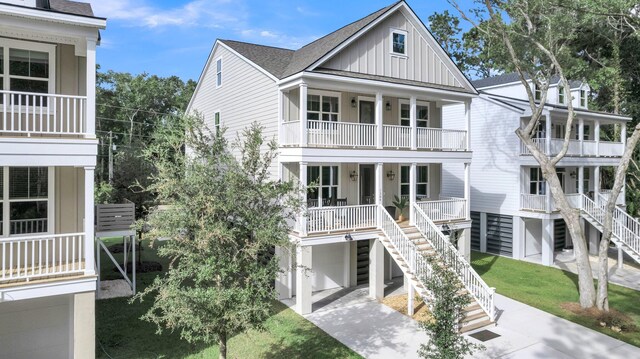 beach home featuring a balcony, covered porch, and a garage