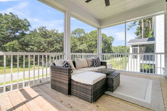 sunroom featuring ceiling fan