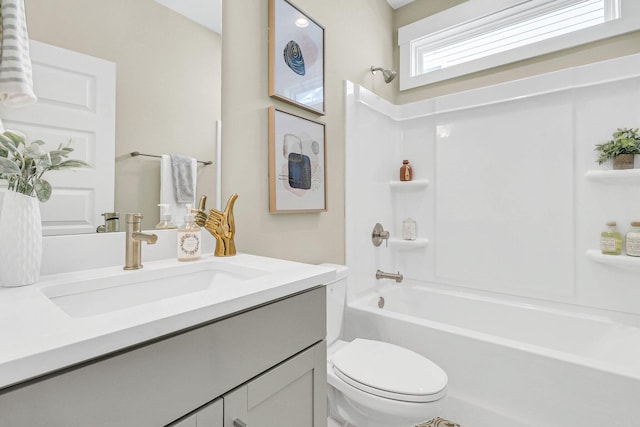 full bathroom featuring vanity, bathing tub / shower combination, and toilet