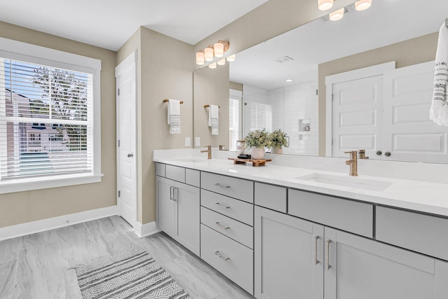 bathroom with walk in shower and vanity