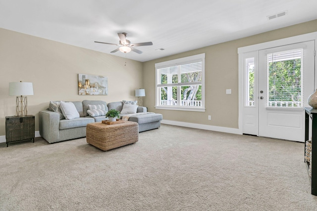 carpeted living room featuring ceiling fan and plenty of natural light