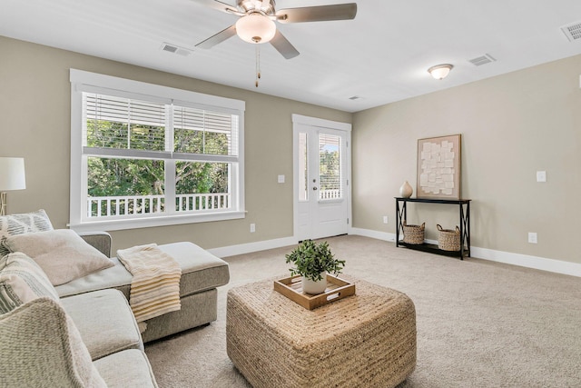 living room with ceiling fan and light colored carpet