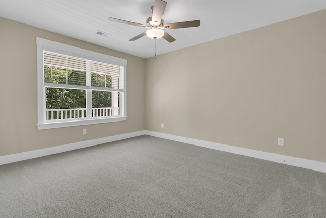 spare room with carpet and ceiling fan