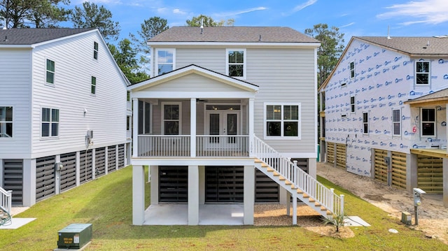 back of property featuring a lawn and a sunroom